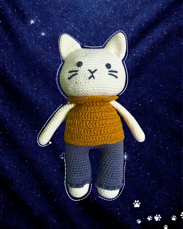 Frontal view of the Purrin cat doll with black safety eyes and whiskers centered on a cinematic dark blue starry background.