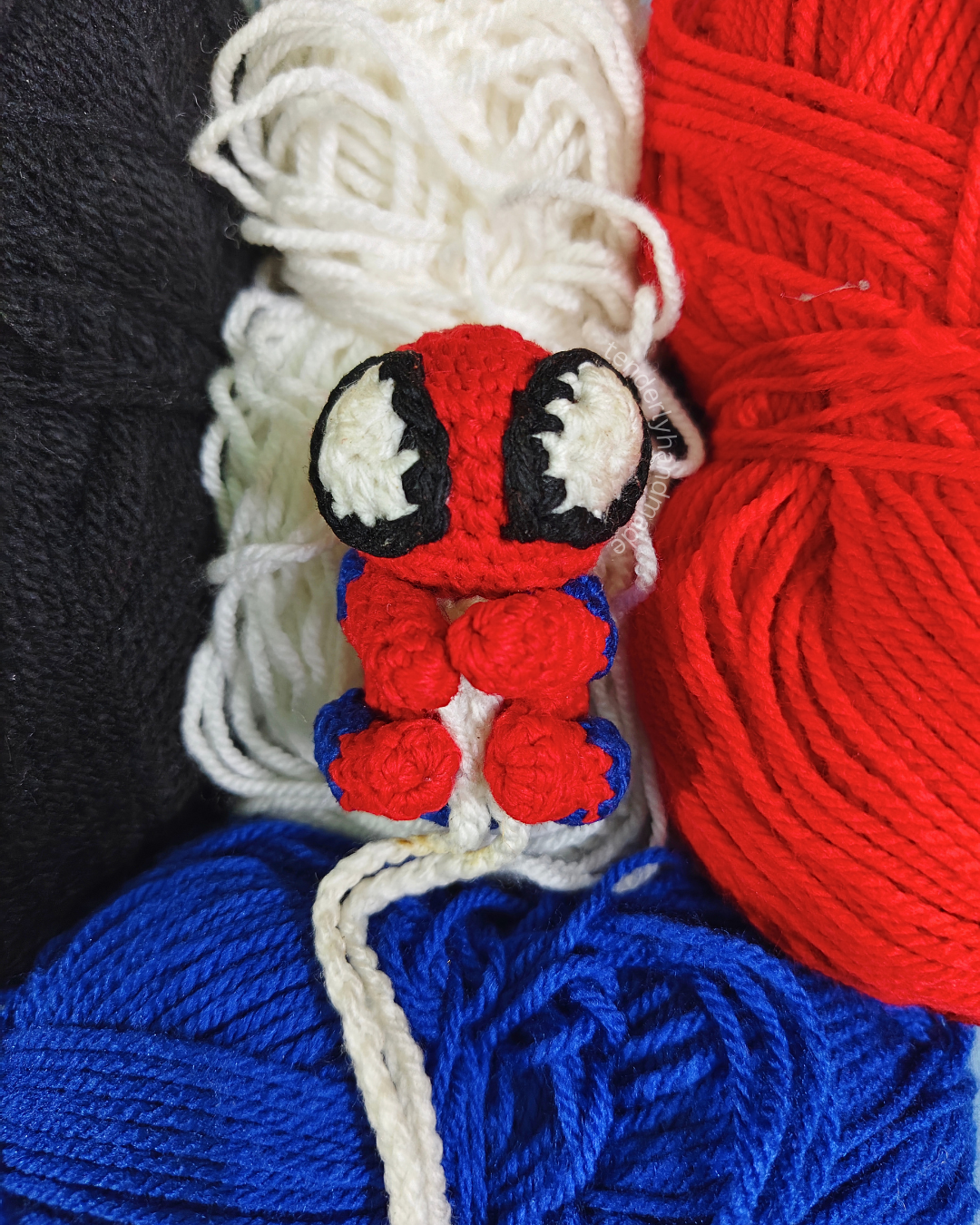 ompact crochet spiderman car hanging miniature nestled on colorful yarn skeins
